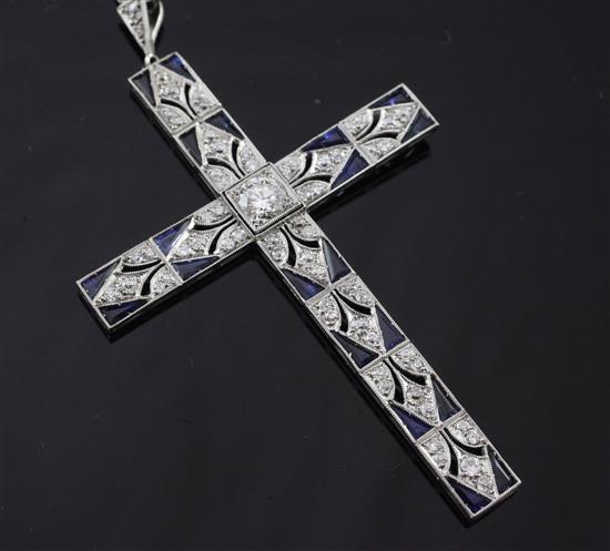 A mid 20th century white gold, diamond and sapphire cross pendant, pendant 3in including bale.